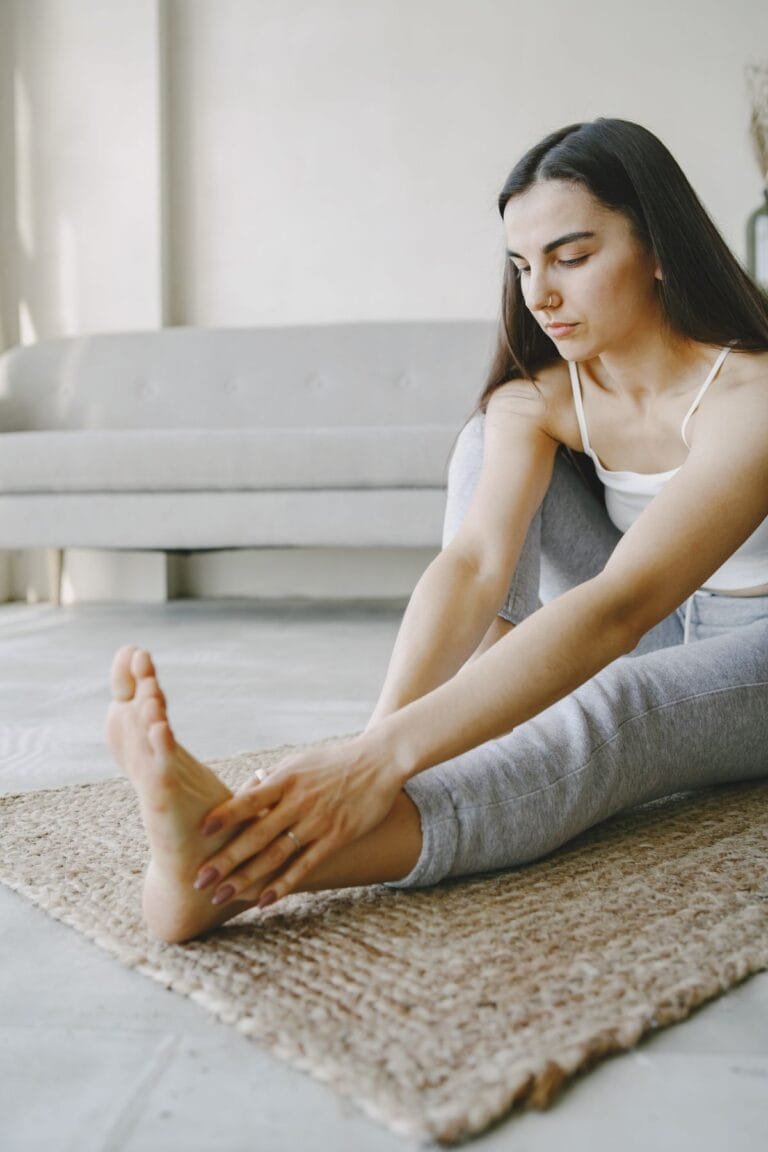 Woman gently stretching at home for ankylosing spondylitis