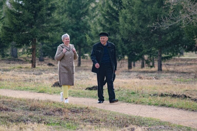 Senior couple walking outdoors, exercise for arthritis patients