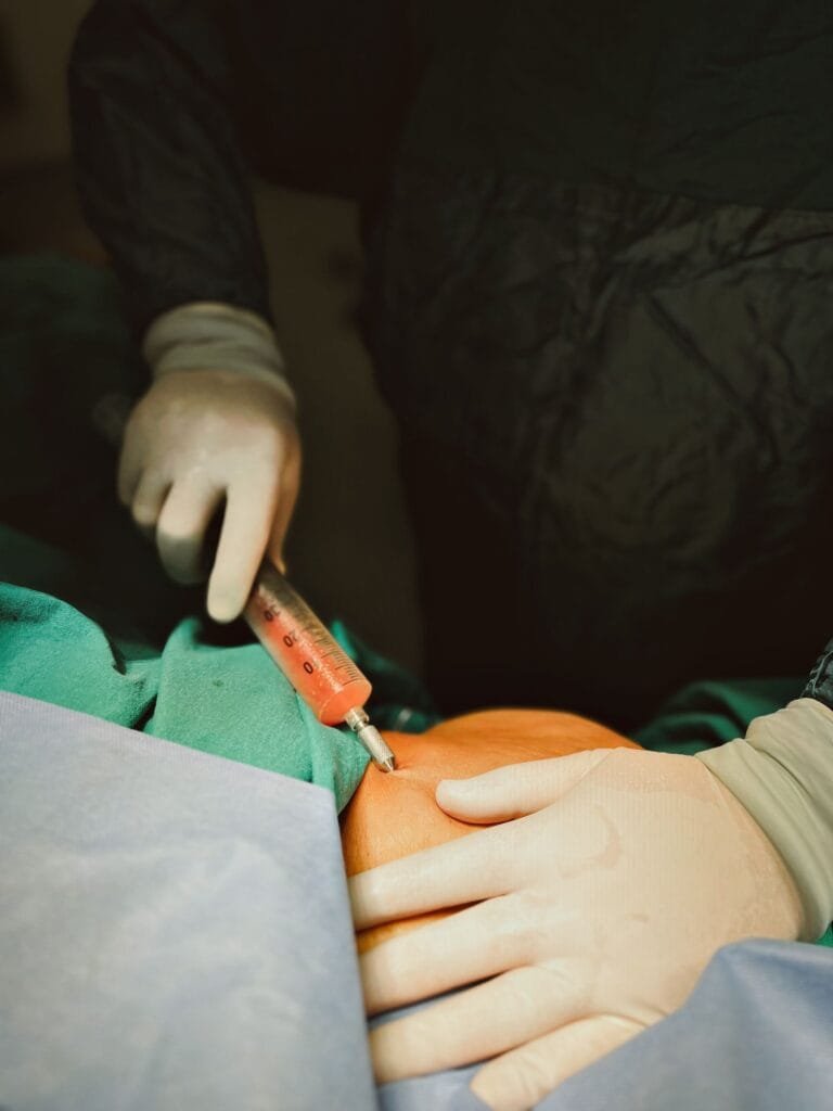 Doctor administering an injection during a pain management procedure